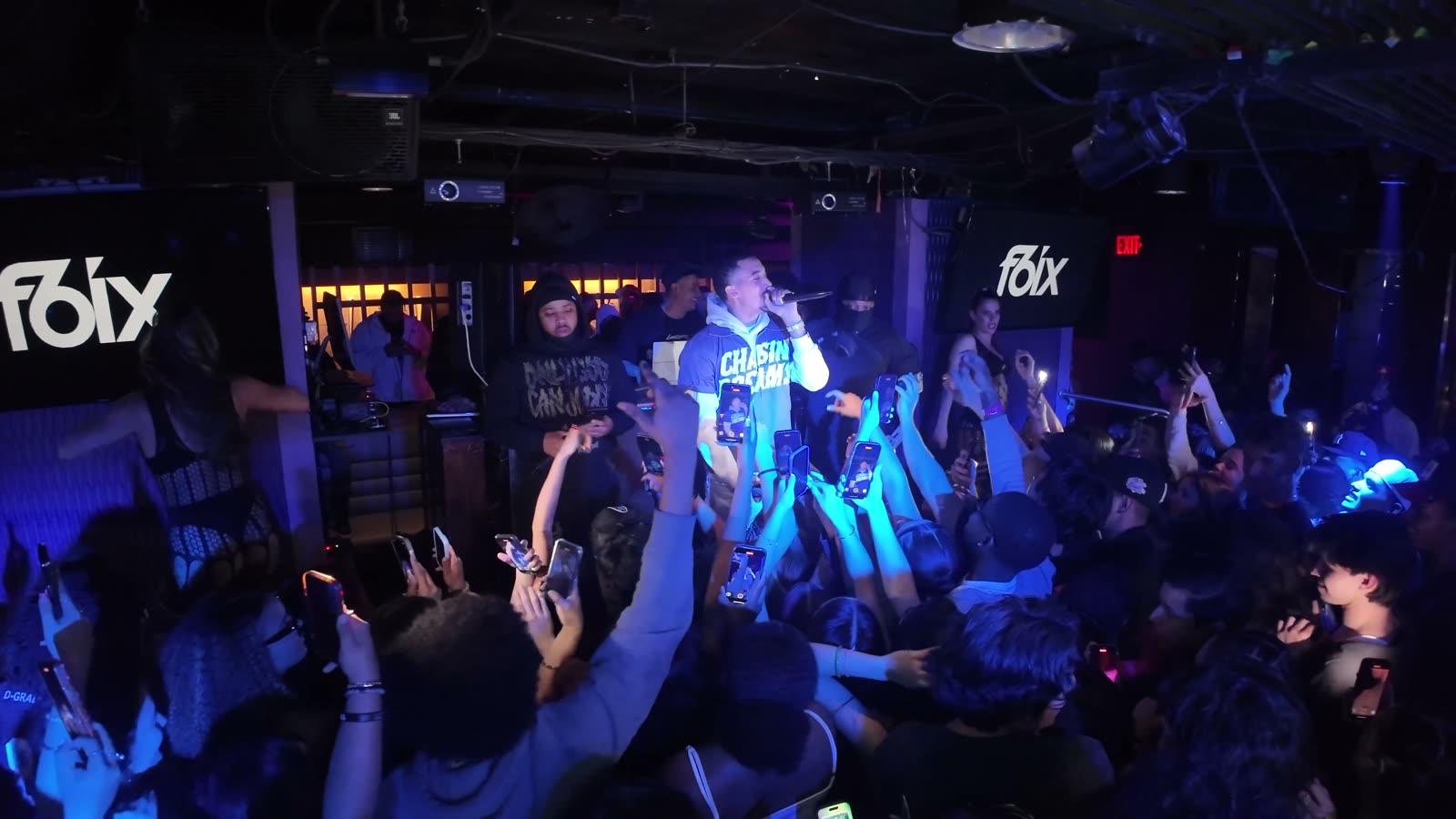 Crowd watching a live performer inside a San Diego nightclub